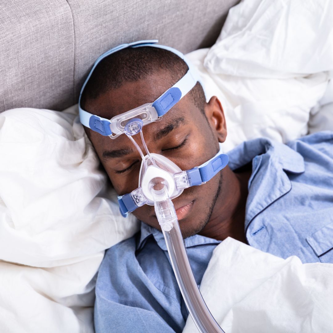 A man wearing a CPAP machine face mask