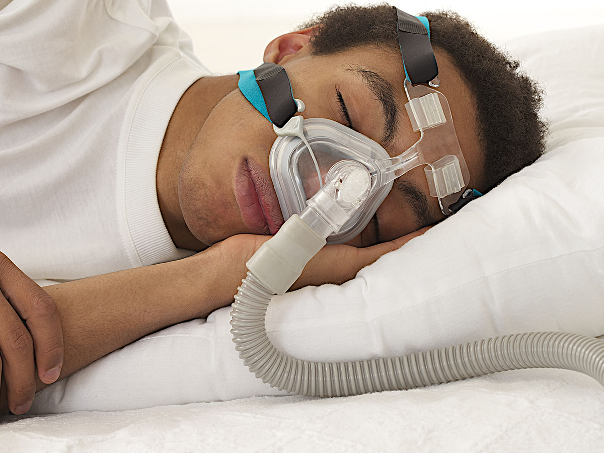 Man sleeping with CPAP mask on