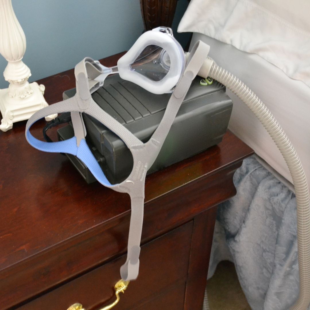A CPAP machine on a nightstand