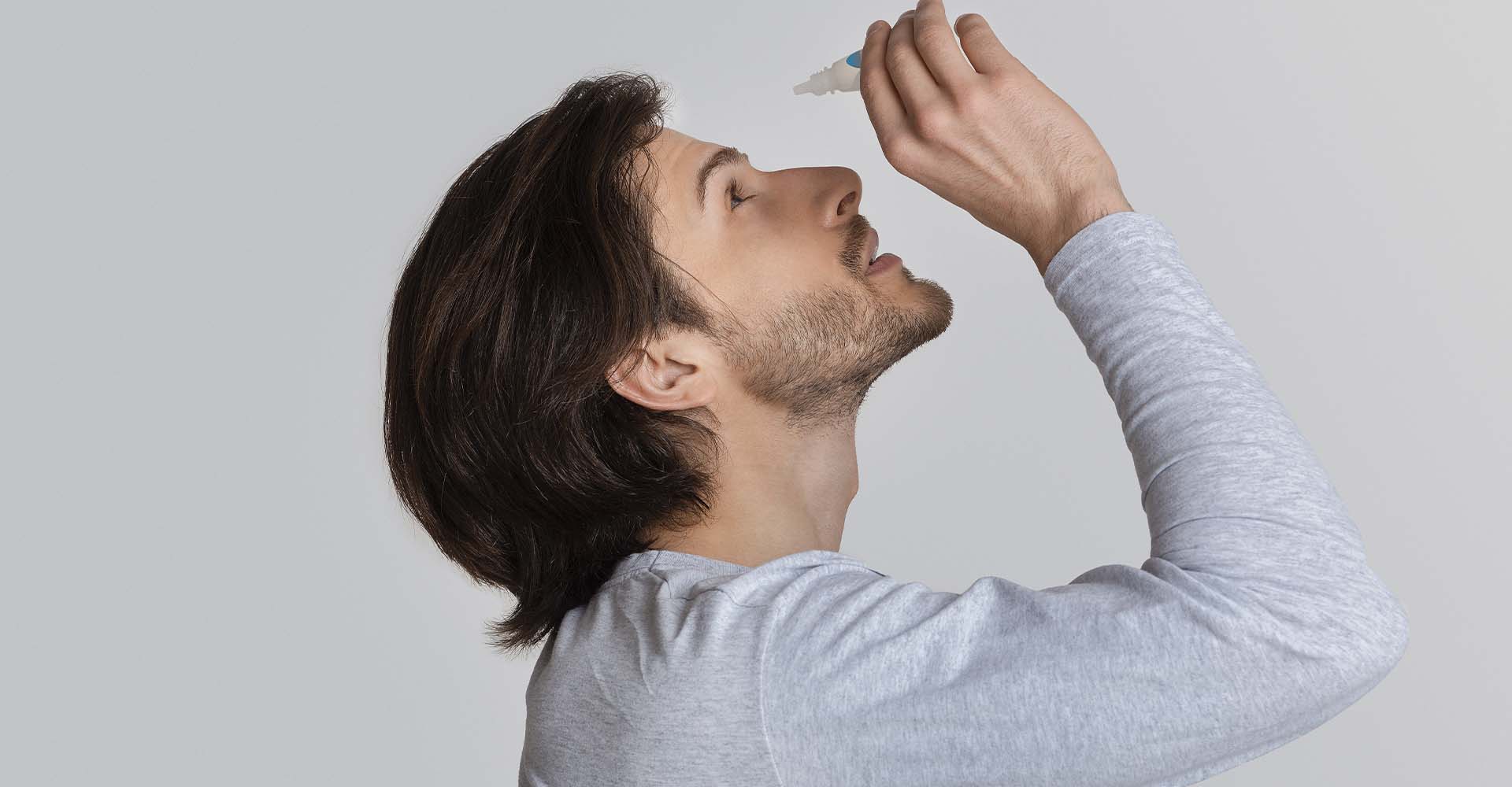 A man using eye drops