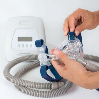 A person inspecting a BiPAP machine